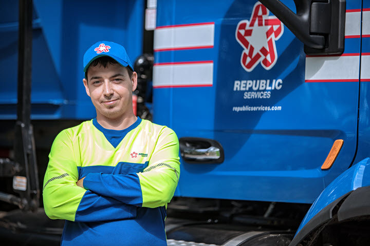 A sign at a waste facility entrance instructing vehicles to stop at the booth, relevant to Benjamin's Rural Disposal operations in Meridian, ID.