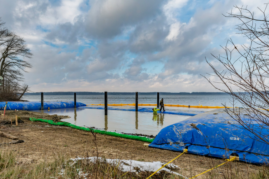 Installation of blue water barriers for a shoreline project by Wilkinson Excavating, Inc. in Meadville, PA
