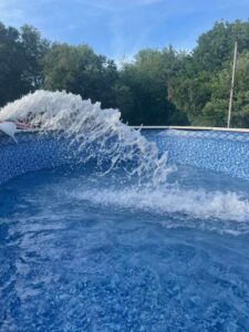 Fresh water being pumped into a newly installed above-ground pool by Advanced Pools and Repair, LLC in Bristol, CT.