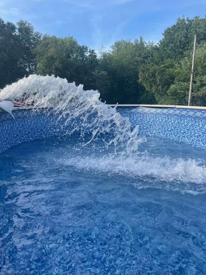 Fresh water being pumped into a newly installed above-ground pool by Advanced Pools and Repair, LLC in Bristol, CT.