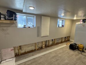 An interior wall with water damage and exposed studs during repair by SurePlan Handyman in North Ogden, UT