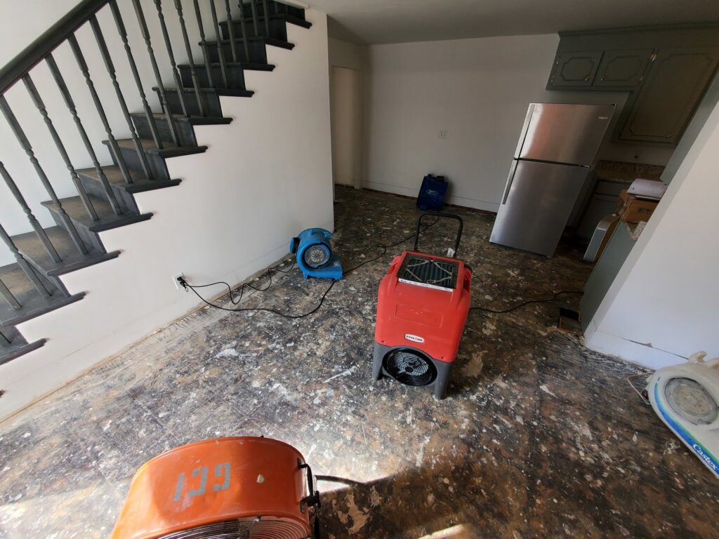 Industrial fans and dehumidifiers used for water damage restoration in a home by GCI Services, Inc. in Simpsonville, SC