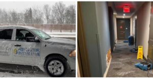 A hallway undergoing water damage restoration with drying equipment and a damaged wall by Professional Restoration in Jersey City, NJ