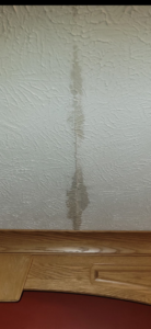 Water damage running down a textured wall, a common repair service by Katzenstein llc handyman in Council Bluffs, IA.