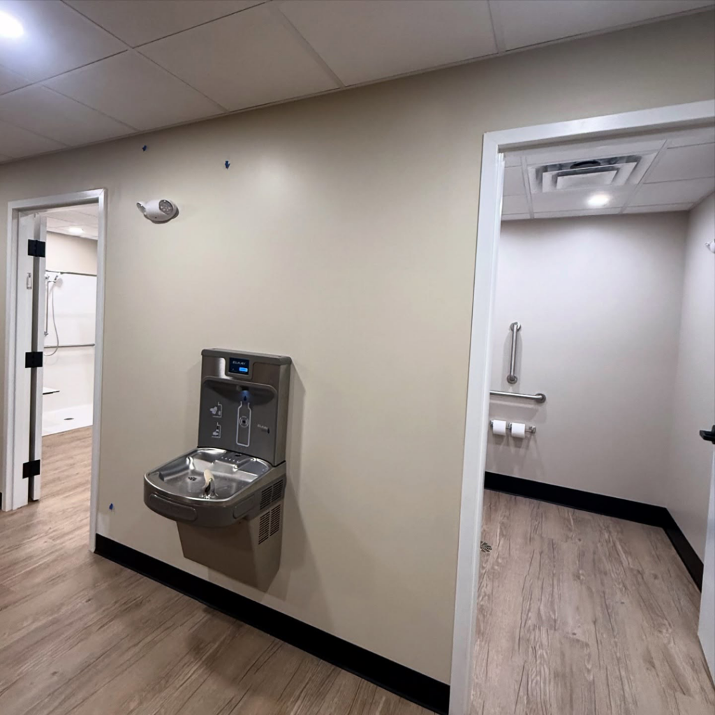 A newly installed water fountain in a hallway, showcasing interior finishing by Crystal Contracting LLC in Clinton, OH.