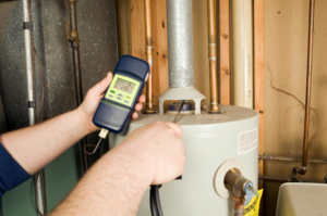 A technician performing a diagnostic check on a water heater at Home Energy Diagnostics in Montclair, NJ