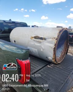 A large water heater being transported in the back of a pickup truck to a landfill by Jigsaw Transport and Waste in Albuquerque, NM.