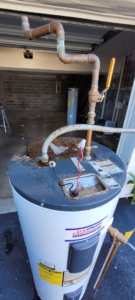 An old water heater being removed for replacement, a service provided by Ray's Property Services in Johnson City, TN