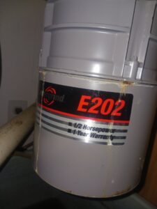 Close-up of the bottom of a water heater showing wiring and potential leak, indicating repair or inspection by Cedar Rapids On Call Handyman Service in Cedar Rapids, IA