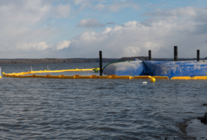 Water-side view of shoreline protection barriers and boom by Wilkinson Excavating, Inc. in Meadville, PA