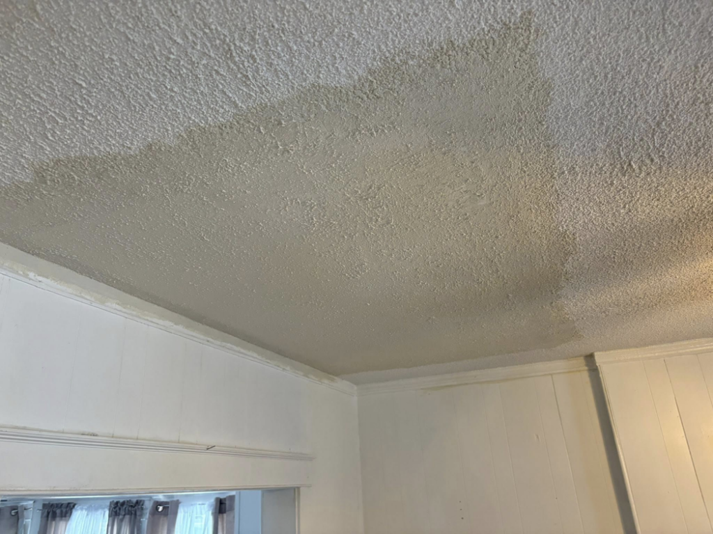 A ceiling showing significant water damage and stains, ready for repair by Gama Home & Lawn Services LLC in Kansas City, MO.