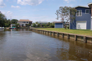 A newly constructed wooden bulkhead along a waterfront property by Spence Marine Construction Inc. in Virginia Beach, VA.