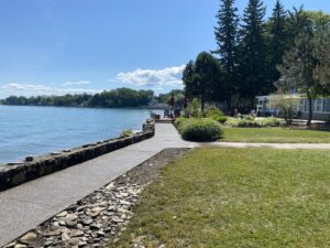 A waterfront concrete path with a stone retaining wall constructed by Paris Brothers & Company, Inc in Erie, PA
