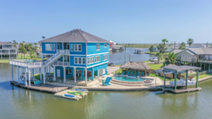 A stunning waterfront custom home with a pool and boat docks, built by Whitley Construction Services in Houston, TX.