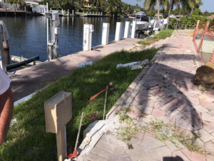Waterfront construction site with damaged walkway and pavers for dock or seawall work by Snapp Industries, Inc. in Miami, FL