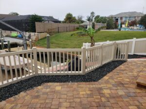 A white vinyl fence installed along a waterfront patio by NGC FENCE INC in Jacksonville, FL.