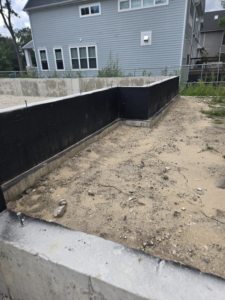 A waterproofed concrete foundation wall, demonstrating quality construction by Specialized Building Services Inc. in Chicago, IL.