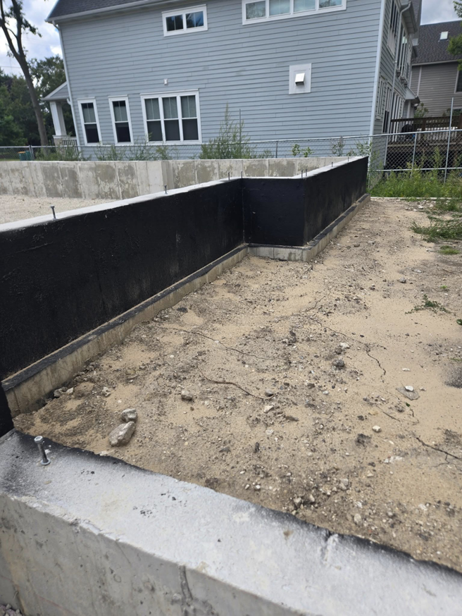 A waterproofed concrete foundation wall, demonstrating quality construction by Specialized Building Services Inc. in Chicago, IL.