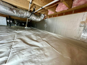 A waterproofed crawlspace with new insulation and a vapor barrier installed by Ramos Waterproofing & Crawlspace Sealing LLC in Durham, NC.