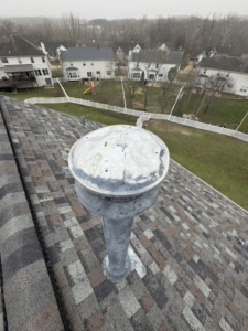 A weathered roof vent on an asphalt shingle roof, indicating potential repair or replacement services from Larson Exteriors in Sunset Hills, MO.