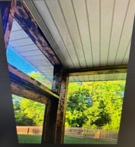 Weathered wooden beams and ceiling of a screened porch, ready for restoration by CParks Pressure Washing and Deck Restoration in Columbia, MO.