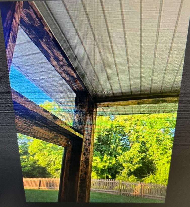 Weathered wooden beams and ceiling of a screened porch, ready for restoration by CParks Pressure Washing and Deck Restoration in Columbia, MO.