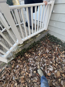 A weathered wooden porch and railing before renovation by Savage Home Builders in Hodgenville, KY