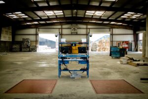 Interior view of a SA Recycling facility showing weighing scales and computer stations for processing materials in Los Angeles, CA.