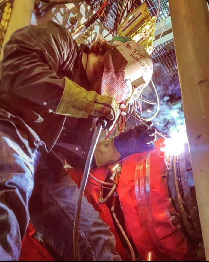 A professional welder performing work in a confined space for Accurity Industrial Contractors, Inc. in Owensboro, KY