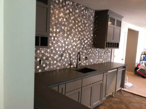 A newly installed hexagonal mosaic tile backsplash in a wet bar area by CSR Tile Construction LLC in Minneapolis, MN.