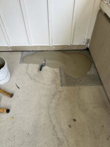 Wet cement or mortar being applied over a mesh for floor preparation by Sal Handyman Services in Canyon Country, CA