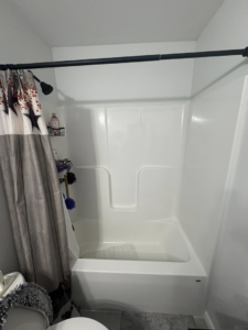 A white bathtub and shower unit installation by Savage Home Builders in Hodgenville, KY