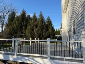 A spacious composite deck with white posts and black railings, built by Harris Home Creations in Philadelphia, PA.
