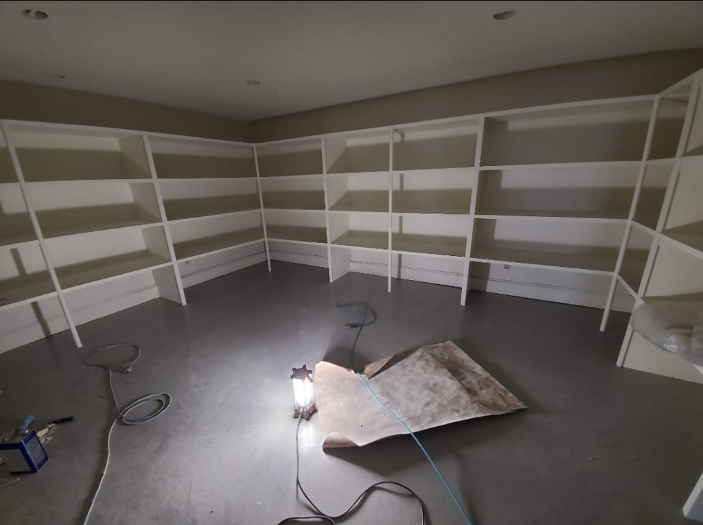 Newly installed white built-in shelving in a room by Blue Ridge Customs LLC in Raleigh, NC.
