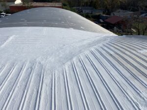 A white coated metal roof, showcasing a commercial roofing solution provided by Roofing Experts Care in Charlotte, NC.