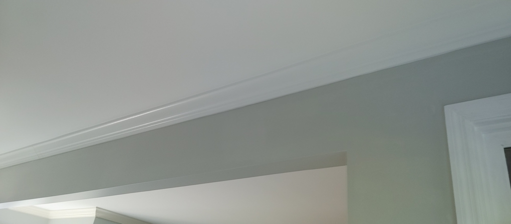 Freshly installed white crown molding on a light gray wall by Just Ducky Painting and Drywall Repair in Pegram, TN.