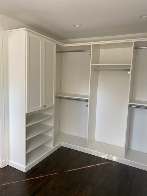 A clean white custom closet system with shelves and hanging rods installed by Closet Creations Inc. in Sleepy Hollow, NY.