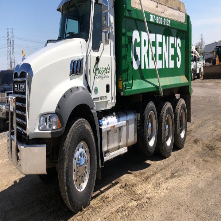 A white dump truck with a green bed from Greene's Roll Off Service in Indianapolis, IN.