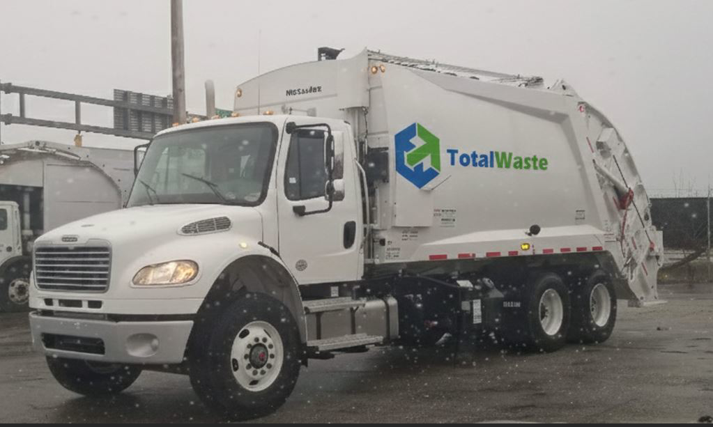 A white garbage truck with the Total Waste logo, ready for junk removal services in Baltimore, MD.