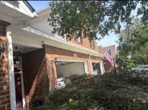 New white gutters installed on the side of a brick house by Knoxville Guttering and Home Improvements in Knoxville, TN.