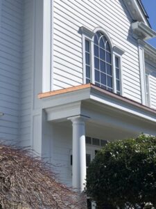 Exterior of a white house showcasing new siding, windows, and copper flashing, completed by Home Made Easy in Norwalk, CT.