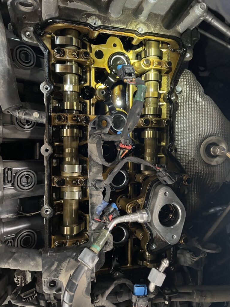White kitchen cabinets with a newly installed over-the-range microwave by Camelback Cabinets in Gilbert, AZ