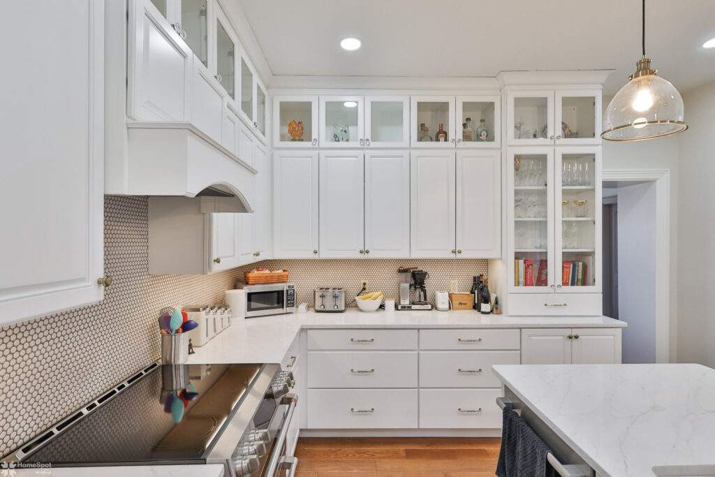A bright white kitchen remodel with shaker cabinets and hexagonal tile backsplash by Shafer Construction, LLC in Bethlehem, PA.