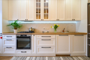 A bright white kitchen renovation with subway tile backsplash and light wood countertops by North Shore Kitchens in Pittsburgh, PA.