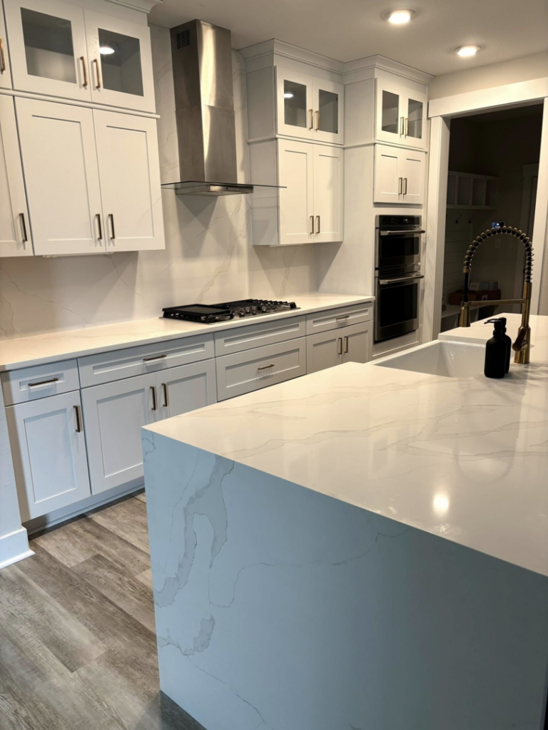 Bright white kitchen with new stone countertops and matching backsplash installed by Dream Stone Countertops in Norfolk, VA