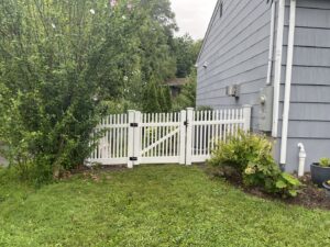 A classic white picket fence and gate installed for a residential property by Fence Factory Inc in Stamford, CT