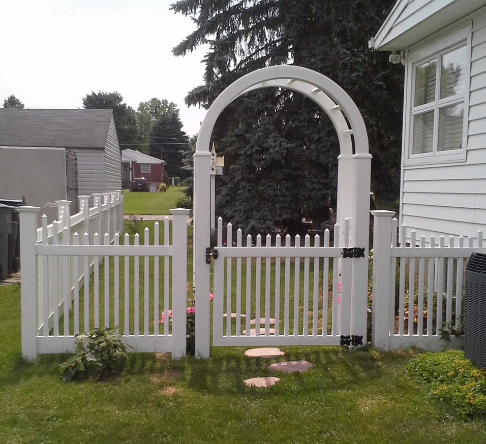 A newly installed white picket fence with an arched gate by R.H. Meyer Fence Co in Cincinnati, OH.