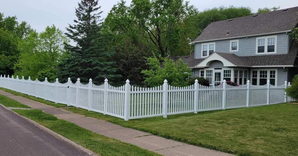 A classic white picket fence installed around a home by Cyclone Fence in Somerset, WI.