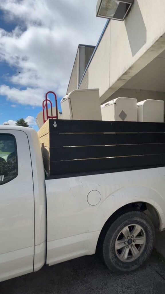 A white pickup truck loaded with furniture and other items for junk removal by Indy Trash Guy in Fishers, IN.