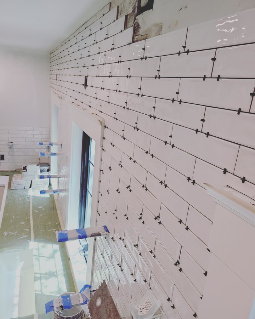 White subway tile installation in progress on a wall by Nation / Phillips Construction in Tacoma, WA.